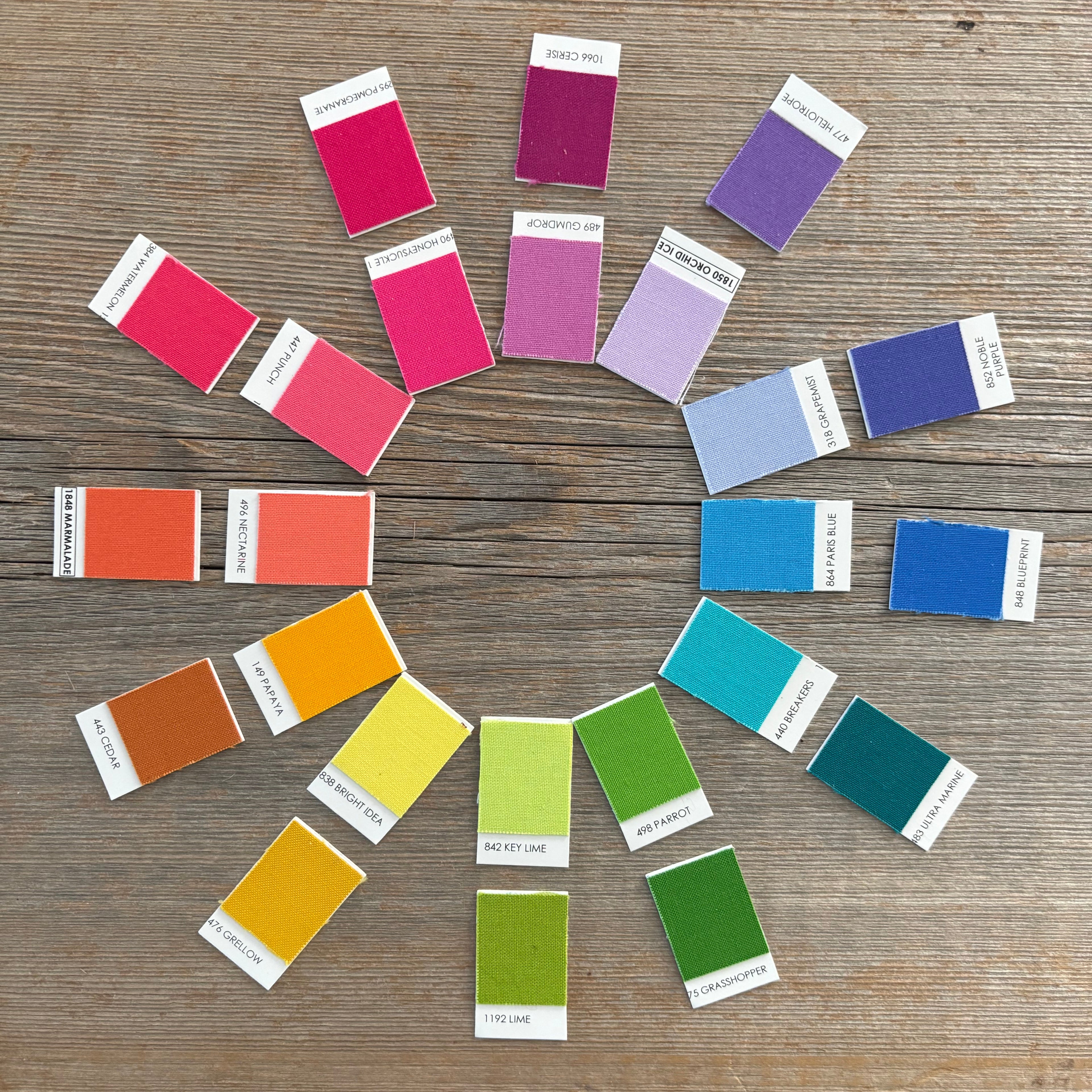 Color swatch samples arranged on a wooden surface