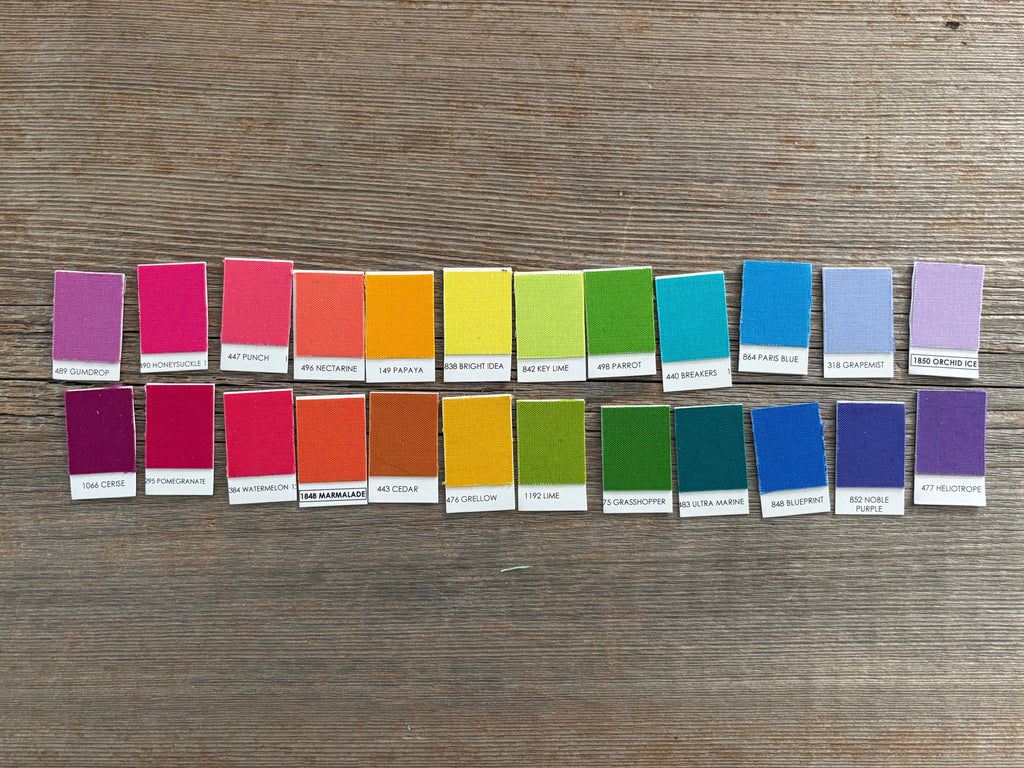 Color swatch samples arranged in a grid on a wooden surface